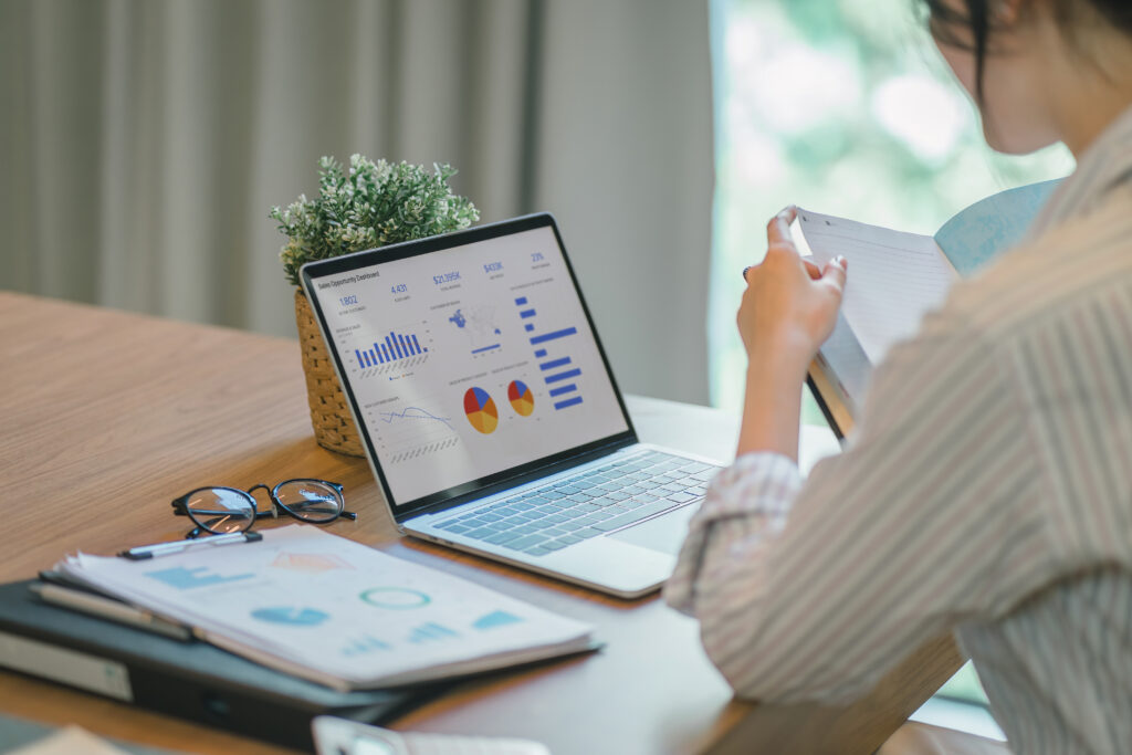 Businesswoman accountant using a graphs and charts to analyze market data balance sheetsaccountsand net profits in order to plan new sales strategies and increase production capacity - ForexMag.cz Investování